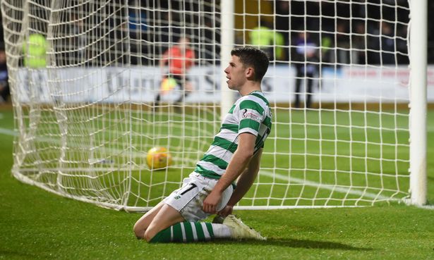 Ryan Christie slides in front of the Celtic fans after scoring. (Getty Images)