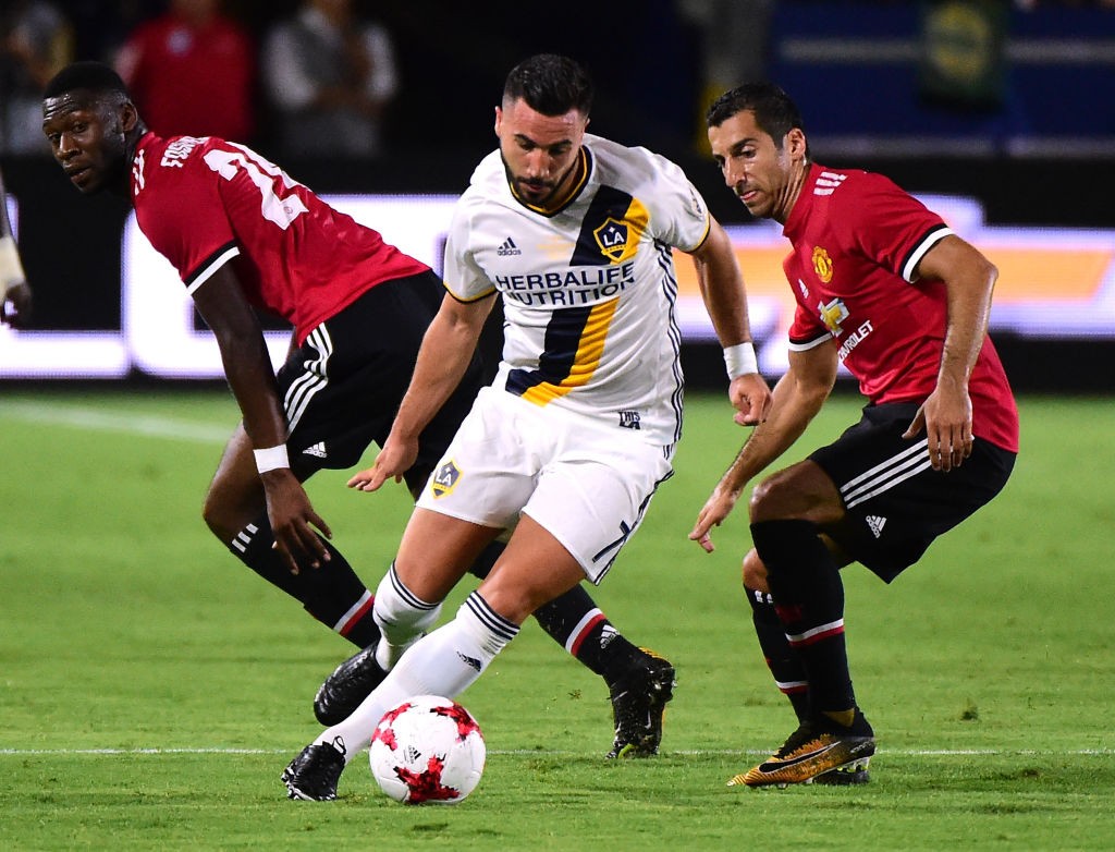 Romain Alessandrini of Los Angeles Galaxy turns from Timothy Fosu-Mensah and Henrikh Mkhitaryan of Manchester United during a 5-2 United victory at StubHub Center. (Getty Images)