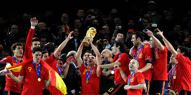 Spain's midfielder Xavi (C) raises the trophy as Spain's national football team players celebrate winning the 2010 World Cup football final Netherlands vs. Spain on July 11, 2010 .