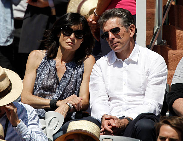 Lyon football team's coach Claude Puel and his wife Corinne attend the match between Spain's Rafael Nadal and Sweden's Robin Soderling during the French Open tennis championship at the Roland Garros stadium,