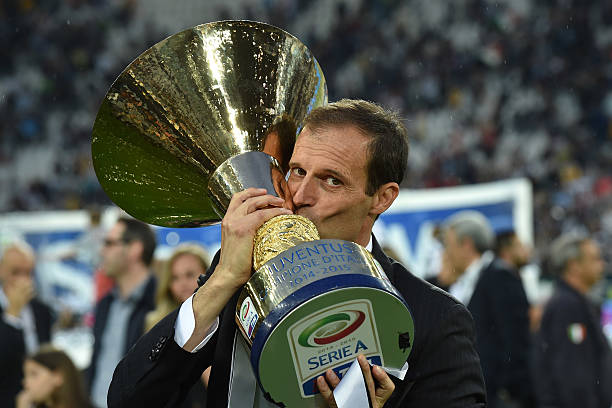 Juventus FC head coach Massimiliano Allegri celebrates with the Serie A Trophy at the end of the Serie A match between Juventus FC and SSC Napoli 