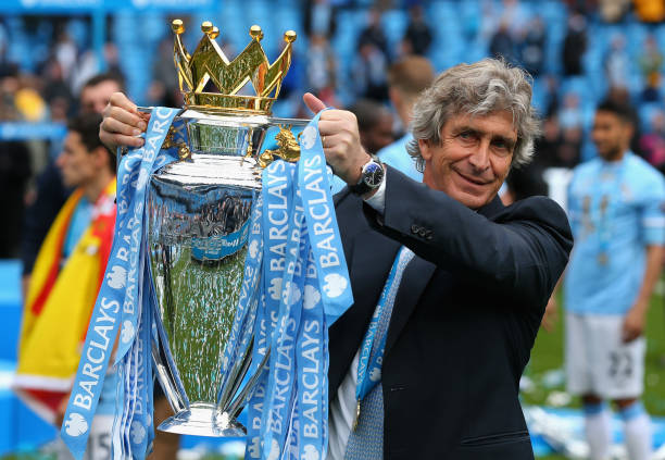  The Manchester City Manager Manuel Pellegrini poses with the Premier League trophy at the end of the Barclays Premier League match between Manchester City and West Ham United at the Etihad Stadium on May 11, 2014 in Manchester, England. 