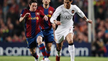 Cristiano Ronaldo (R) of Manchester United holds off the challenge of Lionel Messi (L) of Barcelona