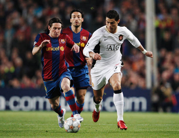  Cristiano Ronaldo (R) of Manchester United holds off the challenge of Lionel Messi (L) of Barcelona 