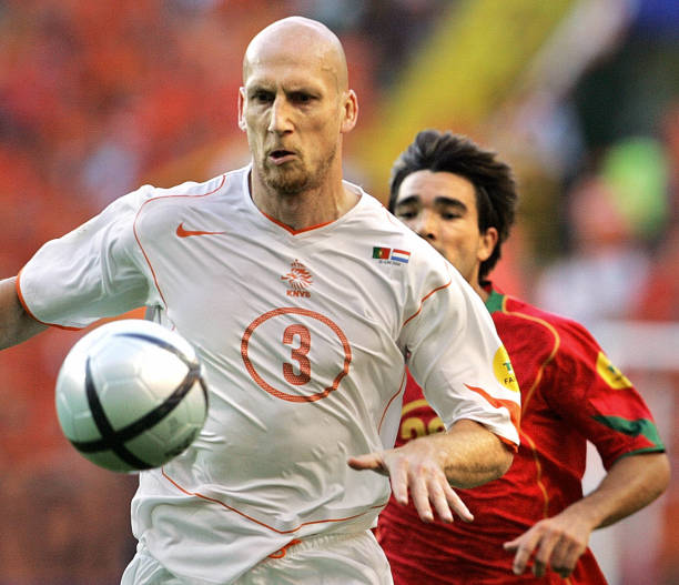 Dutch defender Jaap Stam (foreground) controls the ball in front of Portuguese midfielder Deco, 30 June 2004 at the Alvalade stadium in Lisbon