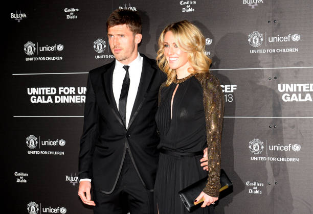 Manchester United's English midfielder Michael Carrick (L) and his wife Lisa pose for photographs as they arrive for a gala dinner in aid of UNICEF at Old Trafford in