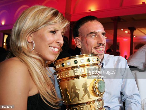 Franck Ribery and his wife Wahiba Ribery hold the trophy during the Bayern Munich champions party after the DFB Cup Final match.  (Photo by Andreas Rentz/Bongarts/Getty Images)