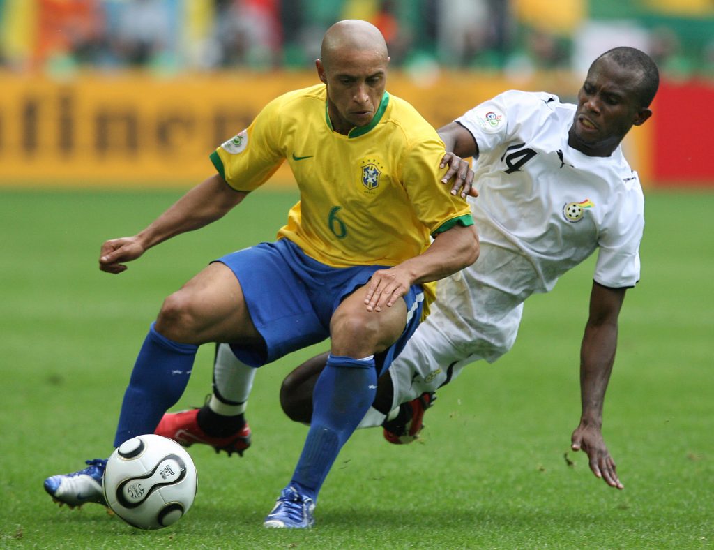 Brazilian defender Roberto Carlos is challenged by Ghanaian forward Matthew Amoah (R). AFP PHOTO / JOHN MACDOUGALL (Photo credit should read JOHN MACDOUGALL/AFP via Getty Images)