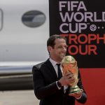 Brazilian football coach, Juliano Haus Belletti who is also a former Brazil national team player disembarks from an aircraft carrying the FIFA World Cup Trophy. (Photo by TONY KARUMBA/AFP via Getty Images)