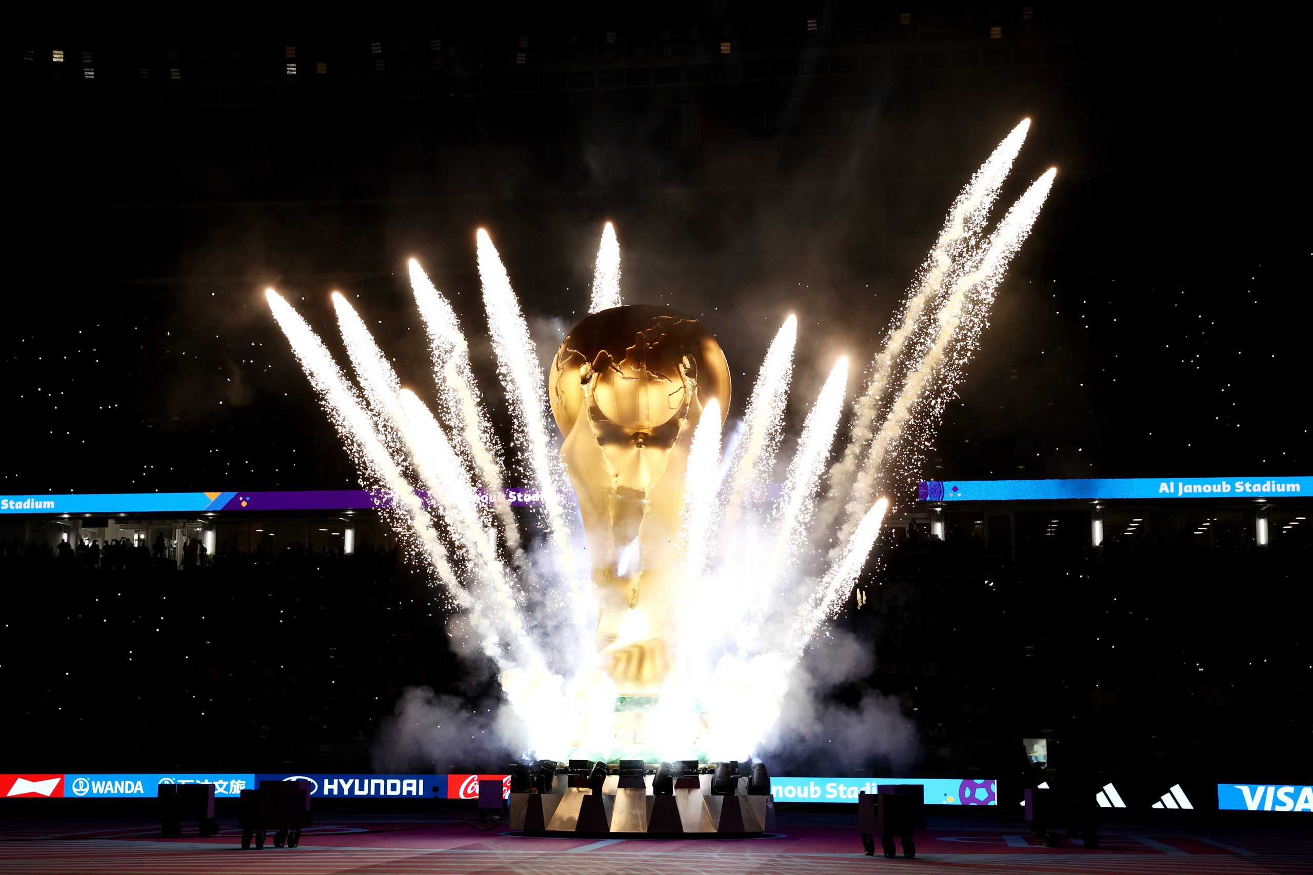 AL WAKRAH, QATAR - NOVEMBER 22: Pyrotechnics explode around a giant FIFA World Cup trophy prior to the FIFA World Cup Qatar 2022 Group D match between France and Australia at Al Janoub Stadium on November 22, 2022 in Al Wakrah, Qatar. (Photo by Robert Cianflone/Getty Images)