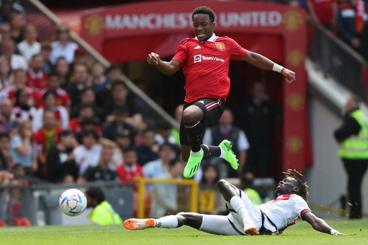 Manchester United's English defender Ethan Laird (L) vies with Rayo Vallecano's Senegalese midfielder Pathe Ciss (R) during a pre-season club friendly football match between Manchester United and Rayo Vallecano at Old Trafford in Manchester, north west England, on July 31, 2022. (Photo by Nigel Roddis / AFP) 