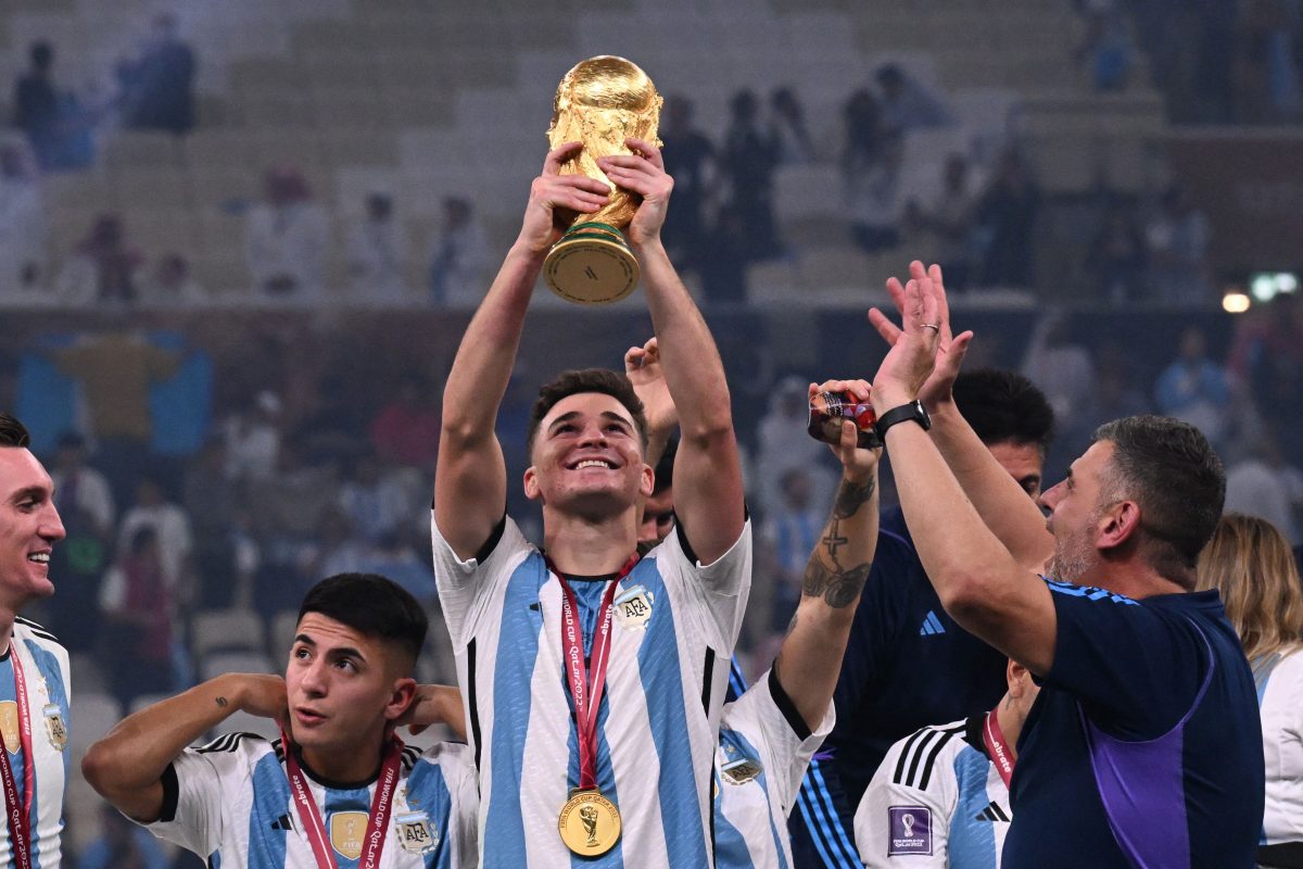 Julian Alvarez lifts the FIFA World Cup Trophy as he celebrates winning the Qatar 2022 World Cup final against France. (Photo by Kirill KUDRYAVTSEV / AFP) (Photo by KIRILL KUDRYAVTSEV/AFP via Getty Images)