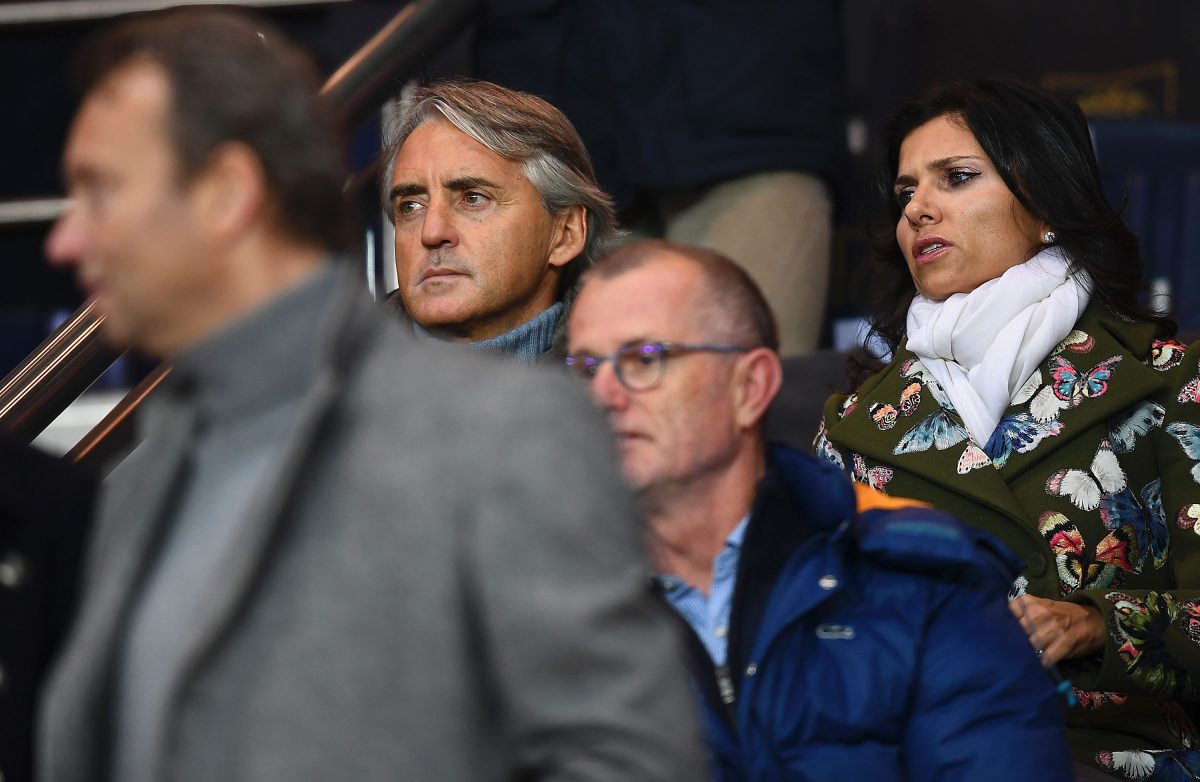 Former head coach Roberto Mancini (L) and his wife Silvia Fortini attend the French L1 football match between Paris Saint-Germain and Monaco. (Photo credit should read FRANCK FIFE/AFP via Getty Images)