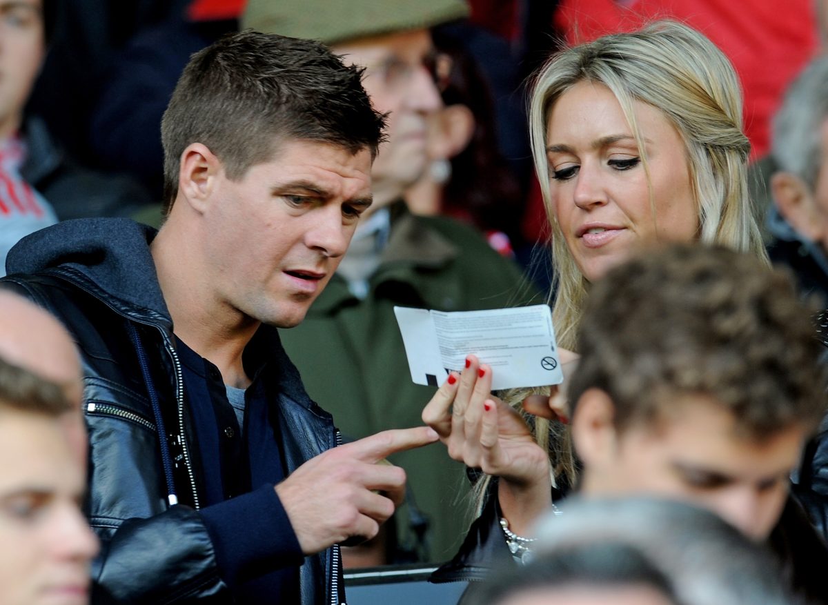 Liverpool's English midfielder Steven Gerrard (R) and his wife Alex Curran arrive to watch the English Premier League football match between Liverpool and Manchester United. (Photo credit should read PAUL ELLIS/AFP via Getty Images)