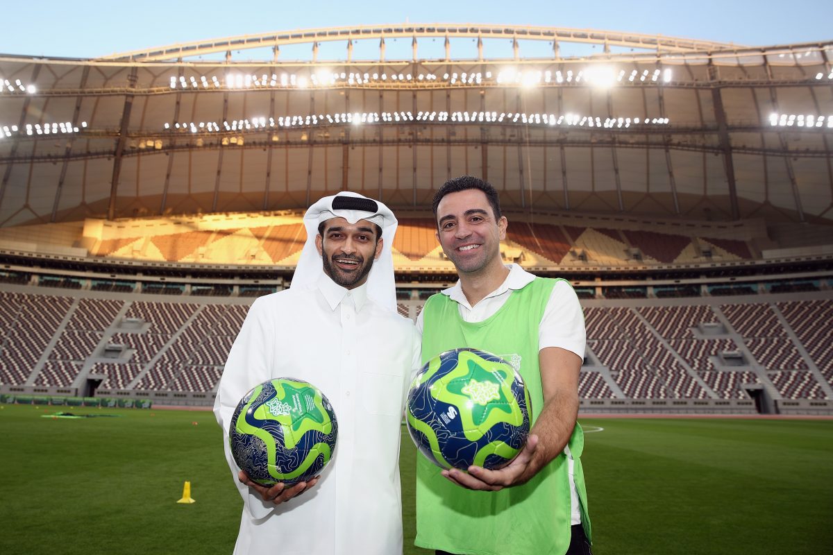 Hassan Al Thawadi, the Secretary General of the Qatar's Supreme Committee for Delivery and Legacy (SC) poses with former Spanish football professional and World Cup 2022 ambassador Xavi Hernandez.  (Photo by Alex Grimm/Bongarts/Getty Images)
