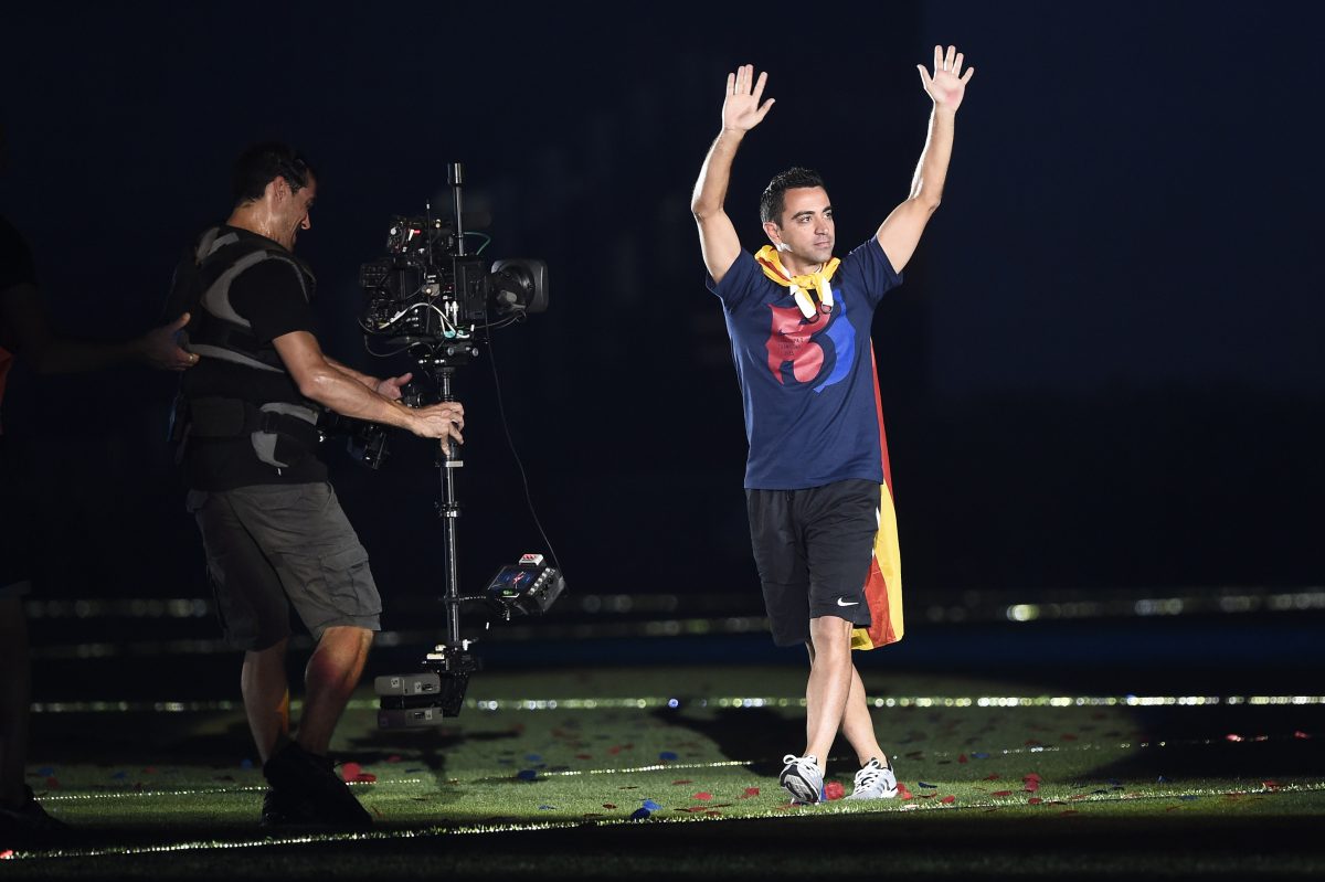 Xavi Hernandez gestures as he enters the pitch to take part in the celebrations held for their victory over Juventus, one day after the UEFA Champions League final football.  (Photo credit should read JOSEP LAGO/AFP via Getty Images)